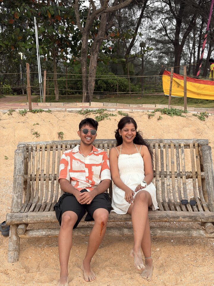 Two people seated together on a park bench.