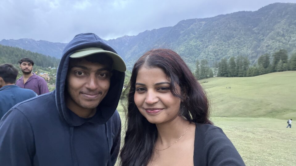 Couple selfie with a mountain backdrop.